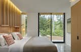 The wood wall cladding continues into the bedrooms, which remain private while also accessing the outdoors.