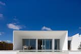 Exterior, House Building Type, Flat RoofLine, Stucco Siding Material, and Beach House Building Type  Photos from A Crisp, White Home in Portugal Soaks Up Sweeping Seaside Views