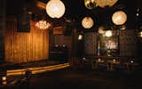 Gold velvet curtains line the stage, which features a DJ or live music nightly, in a selection curated by Justin Gage of Aquarium Drunkard. Gilt chandeliers and textured walls complete the scheme.