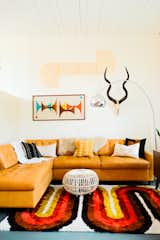 On the other side of the living room, Nagel combined a leather Joybird sectional sofa with an AllModern rug.