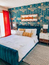 For a bedroom accent wall, Nagel chose Justina Blakeney's Cosmic Desert wallpaper in teal, also from Hygge and West, and paired it with a Joybird bed and bright red curtains. 