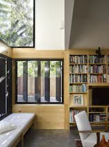 Light cascades onto the window seat from glazing placed high on the wall.
