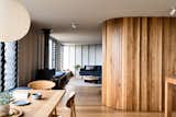 Upstairs, a curved wall clad in Silvertop ash joinery gently separates the living room from the kitchen and dining area. On the kitchen side, the wall hides the pantry and fridge.