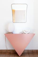 In a hallway, the Single Triangle Console powder-coated pink, from the Cuffhome collection, makes for a striking statement piece.