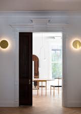 Modern lighting, including Ross Gardam's Polar wall lamp, provides contrast with the historic architecture.