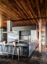 The stainless-steel kitchen system is by Bulthaup, and the countertop was fashioned by Brooklyn–based Wüd Furniture Design.