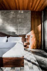 In a bedroom, the walnut live-edge bed is a custom design from Emily Summers Design Associates.