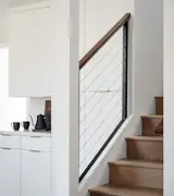 Stairs clad in the same wood as the floor, European oak, lead up to the second-floor addition, which is now home to a 500-square-foot principal suite.