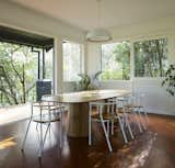 In the new dining room, the firm surrounded a table commissioned from Ross Didier with Half Hurdle chairs in white and oak from Doweljones. An Ora pendant from Ross Gardam hangs above the table.