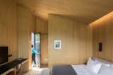 Wood paneling wraps the interior of a trapezoidal cabin.