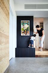 The firm placed an entry hall at the nexus where the addition meets the original house, with the door to the master suite on the left. Built-in storage, here clad in charred wood, is designed for flexibility of use and accessibility to children and adults alike.