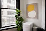 LaValle worked with a good friend and colleague Sarah Hurt of Seattle Art Source to find pieces for the studio, many of them by local artists. In a corner of the kitchen, a piece by the Portland, Oregon–based Mia Farrington hangs above a Daewoo fridge and trashcans by Brabantia.