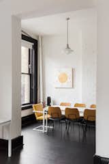 At the conference area, a Pratt Conference Table from Room &amp; Board is surrounded by the Versus chair from Article. The wall artwork is by the Seattle–based Jennifer Ament.