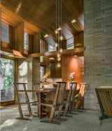 Major interior moves include restoring the tinted concrete flooring throughout, as well as the abundance of Philippine mahogany in the ceiling, walls, and cabinetry. The team also built custom furnishings designed by Wright, such as the dining room table, here surrounded by Nakashima chairs.
