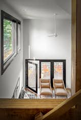 At the end of the hall, a landing overlooks the living room, which has access to the backyard. The stairway leads up to the third floor, which has a bedroom and bonus office.