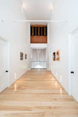 In the guest wing, the church’s Casavant organ still resides with its pipes intact. The keyboard (not pictured) is still accessible so that the organ can be played. "Even after the transformation, we still feel the original acoustic in the building," says Pierre. "It is majestic…The sound of the bell makes the villagers smile, and the sound of the organ makes the whole building vibrate, and there’s the incredible impression of living in a building that will last forever."