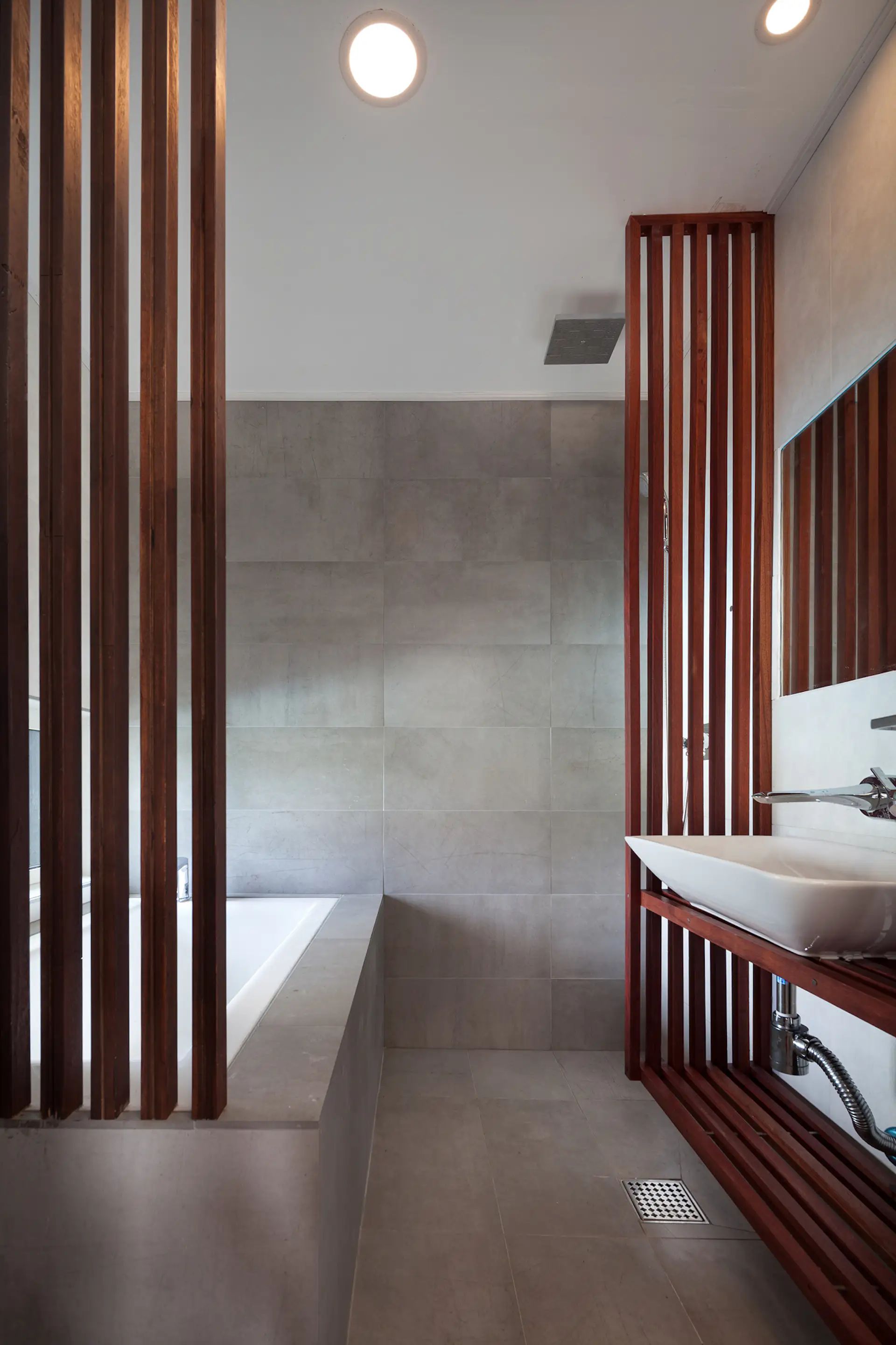 Stone tile and wood accents in the bathroom.