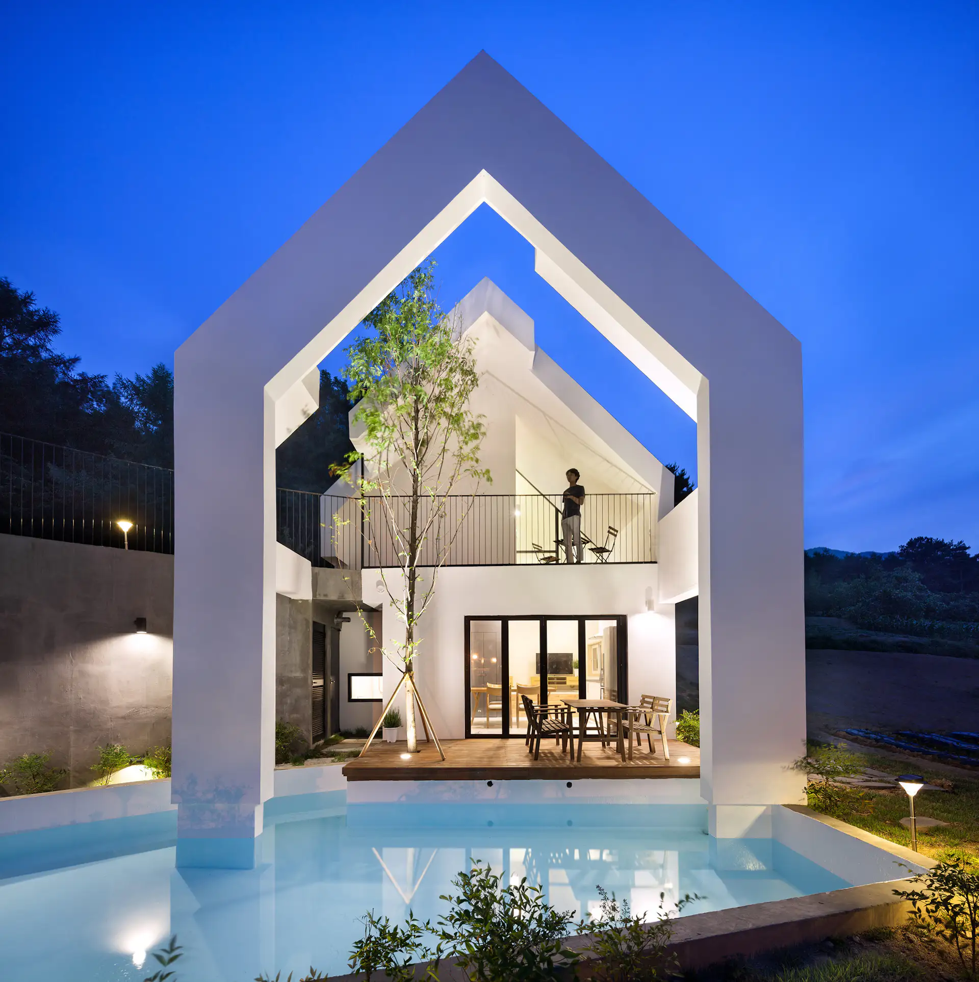 Night lighting emphasizes the dramatic form of the building.