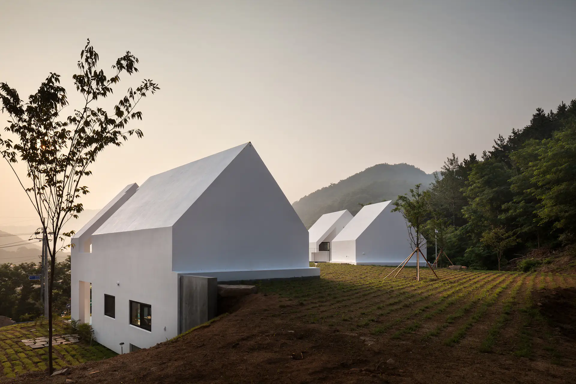 The two structures are connected by green space.