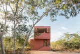 In order to create a small yet comfortable vacation home for a young couple, the multidisciplinary workshop TACO, or Taller de Arquitectura Contextual, sited it in the corner of a two-acre lot, then employed built-in elements for an "intuitive" interior layout.