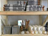 Toiletries and bath supplies include the Rainy Day towel collection by Donna Wilson, wool and leather tissue box covers by Graf Lantz, and West Third Brand perfumes.