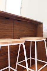 The solid walnut eat/work counter has two interior cabinets tucked underneath, as well as exterior hatch storage access. The Modern Caravan also outfitted the stools with new wood seats.