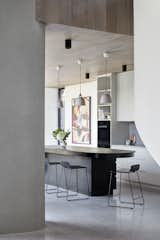 Polished concrete veneer floors in French Grey from Pangaea run throughout the shared living spaces.