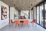 The ceilings in the adjoining kitchen and dining room are defined by porcelain “timber look” tile from Solaris. The curve of the exterior columns carries inside.