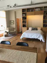 "In about a minute and a half you can put the bed away, slip the nightstands up, and it all disappears so it looks like a library," says McCuen of the maple Murphy bed and bookcases in the master bedroom.