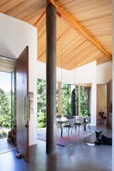 The scale and diameter of a concrete support pole deliberately matches the scale of the trees outside. Thanks to careful siting, the dining room has views of both the mountains and ocean.