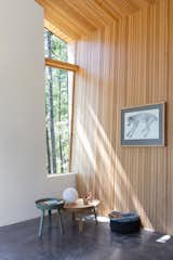 A more narrow window focuses the eye on tree trunks, creating an “abstracted view of the landscape,” says the firm.
