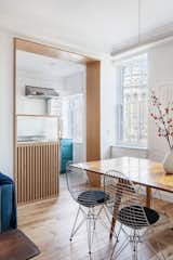 A fluted glass-and-wood peninsula still lets natural light flow between the rooms.