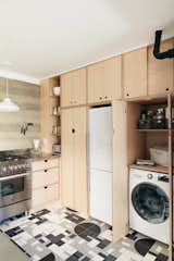 The wall of cabinetry conceals a washer/dryer unit as well.