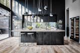 In the kitchen, Laminex Absolut Matte Black cabinets are topped with counters from Pop Concrete.