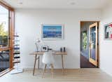 An Artifox Desk 02 sits with an Eames chair in the lower-level office/spare bedroom. While the lower deck has been rebuilt, the interior of the lower level is currently being redone to provide guest spaces for visiting family and an entertaining area.