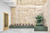 The original limestone walls were cleaned up, and the new design bookends the apartment with courtyard spaces.