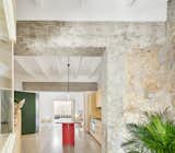 Architect Mariana de Delás converted a crumbling motorcycle repair shop into a two-bedroom apartment in the city of Palma on the island of Mallorca in Spain. The architect pared back the material palette throughout the 990-square-foot home in order to highlight the traditional Mallorcan limestone used for the shell of the building.