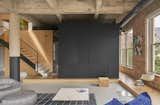 The master bedroom, or "sleeping cube," is tucked inside a black steel framework with a storage side facing the living room.