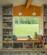 Now, the playroom can be accessed by the son’s bedroom or at the hallway. Custom woodwork fashions storage and a window seat.