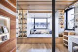 A view of the master bedroom portion of the apartment illustrates how the designers made every square inch of the home multifunctional. The bed platform is surrounded by smart storage and doubles as a stage for singing, or extra seating on movie nights.