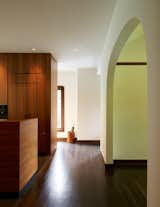 In the previous floor plan, the dining room was closed off from the kitchen and accessed by swinging doors. Paying special attention to how the old and new spaces meet, the architects widened the opening between the old dining room and new kitchen, and installed a plaster arch that reflects the home’s historic character. 