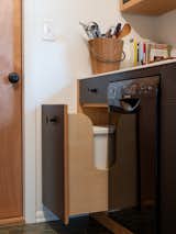 A black, 18-inch Bosch dishwasher and black hardware from Schoolhouse Electric disappear against the cabinet fronts, rather than cluttering the small room with distracting detail.