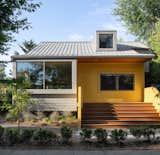 After: Now the bright yellow and gray facade is distinguished by oversize windows.