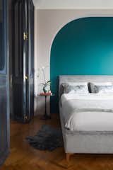 A shade of “Art Deco green” bedecks the wall behind the gray velvet Andes Deco bed by West Elm.