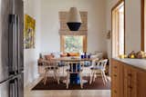 In the new dining area, a Dreamweaver pendant from Pop & Scott is suspended over an Agostino & Brown Jam table in oak with a navy powder-coated base. Bleached ashwood Nym chairs by Pedrali surround the table.