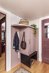 The renovation of a Victorian-era home in Portland, Oregon, included updating the entry area with new storage and a muted pink hue, picked in collaboration with the client. "She wasn't afraid of color," says&nbsp;Stephanie Dyer of Dyer Studio, who paired it with a deeper burgundy shade for the doors.