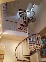 Before: A massive spiral staircase spanned the entire height of the home, and cut through a bedroom on the second floor. The height, tight tread, and gaps between the balusters made the staircase unsafe to traverse.