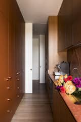 The corridor is 26 feet long and hosts a bar, sink, pantry, laundry, and drying room. Pocket doors allow the laundry to be closed off when needed.