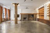 Before: The 2,700-square-foot loft had a sizable great room with enviable features, including exposed brick walls and heavy timber structural beams. 