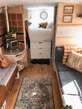 The rear of the bus holds the platform bed, warmed by a Cubic Mini Grizzly Woodstove ($900) enclosed by a terra-cotta tile heat shield ($90). When the bus was snowed in at a campground in Nederland, Colorado, the wood stove came in handy. "It was actually a wonderfully cozy, delightful experience. For three days we lived in our tiny home, cooking, reading, and hiking with our adventure pup," says Timothy.